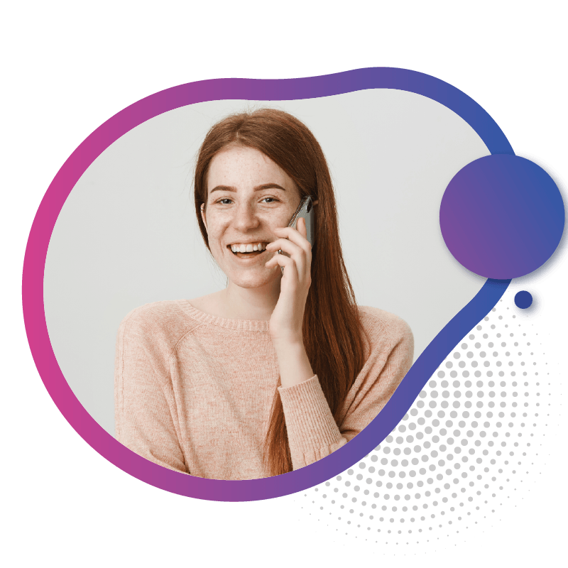 A woman with long red hair wearing a soft pink sweater holds a phone to her ear, set against a neutral background, symbolizing the ultimate mobile access and seamless communication offered by eSIM technology in Australia